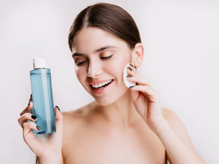 mulher a usar água micelar no rosto